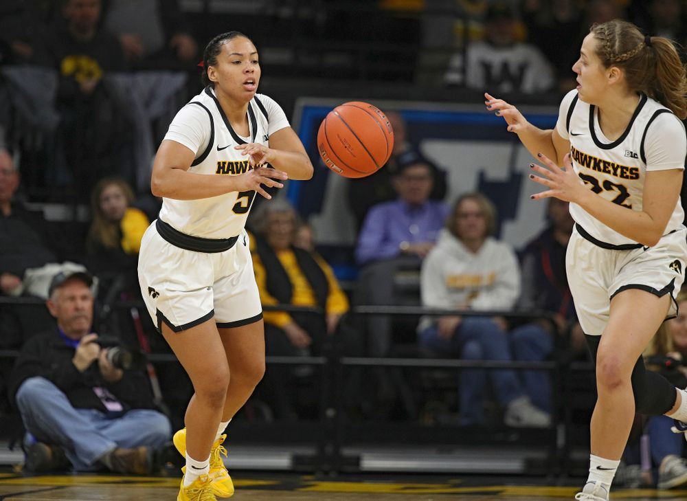 Iowa Hawkeyes guard Alexis Sevillian (5) passes the ball to guard Kathleen Doyle (22) during the first quarter of their game at Carver-Hawkeye Arena in Iowa City on Sunday, January 26, 2020. (Stephen Mally/hawkeyesports.com)