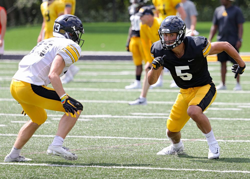 Iowa Hawkeyes wide receiver Oliver Martin (5) looks down field as linebacker Joe Evans (13) defends during Fall Camp Practice #5 at the Hansen Football Performance Center in Iowa City on Tuesday, Aug 6, 2019. (Stephen Mally/hawkeyesports.com)