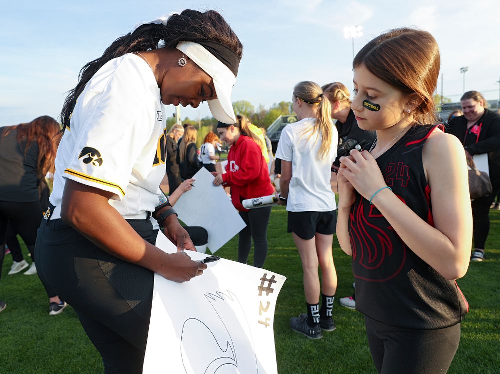 Iowa's DoniRae Mayhew (24) signs a poster for a fan after winning their game against Ohio State at Pearl Field in Iowa City on Friday, May. 3, 2019. (Stephen Mally/hawkeyesports.com)