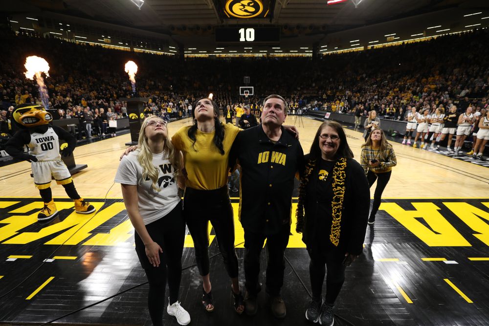 Megan Gustafson stands with her family as her number is raised into the rafters during a jersey retirement ceremony Sunday, January 26, 2020 at Carver-Hawkeye Arena. (Brian Ray/hawkeyesports.com)