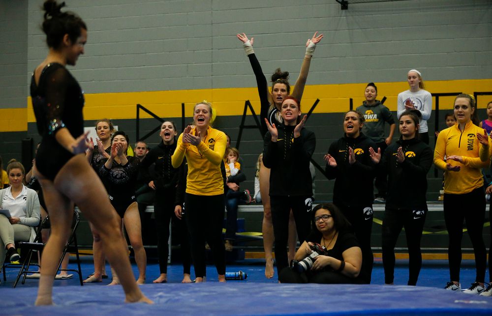 Iowa Hawkeyes gymnasts react during Gina Leal's floor routine during the Black and Gold Intrasquad meet at the Field House on 12/2/17. (Tork Mason/hawkeyesports.com)