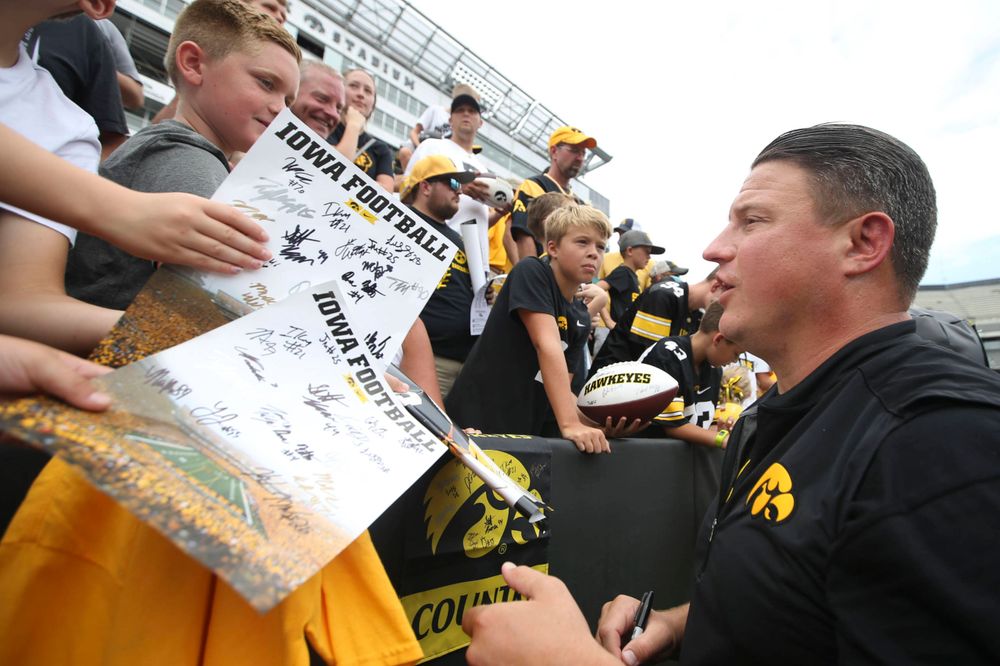 Iowa Hawkeyes offensive coordinator Brian Ferentz signs autographs during Kids Day at Kinnick Stadium on Saturday, August 10, 2019. (Lily Smith/hawkeyesports.com)