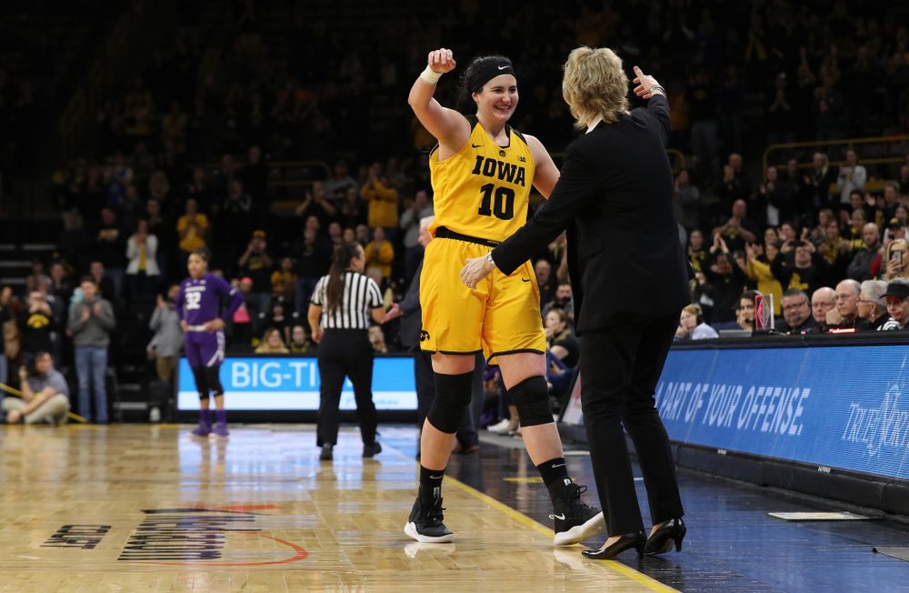 Iowa Hawkeyes forward Megan Gustafson (10) hugs head coach Lisa Bluder as she lives the court for the final time against the Northwestern Wildcats Sunday, March 3, 2019 at Carver-Hawkeye Arena. (Brian Ray/hawkeyesports.com)