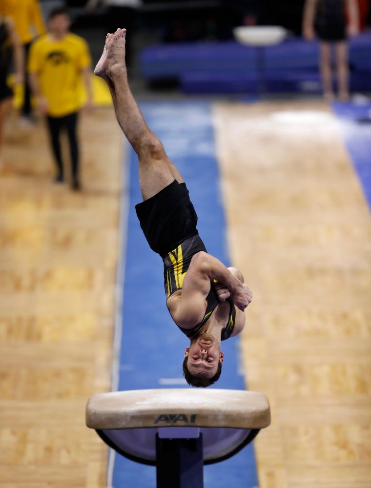 Dylan Ellsworth competes on the vault against Illinois 
