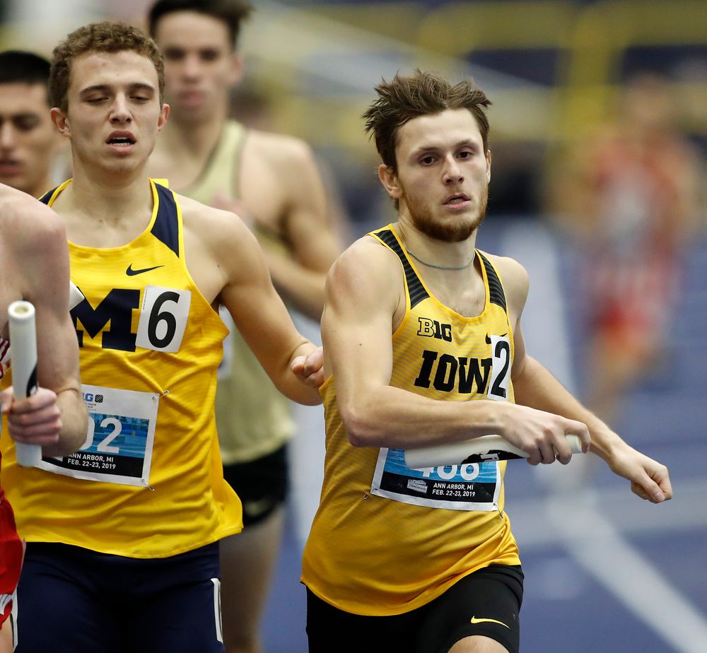 Tysen VanDraska gets a nudge form a Michigan runner 
