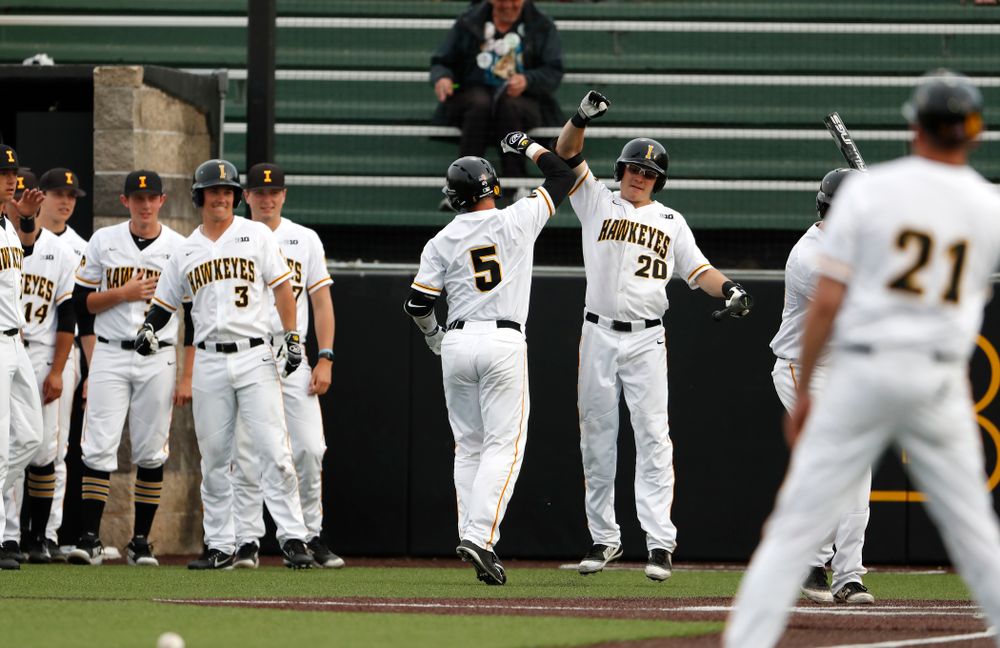 Iowa Hawkeyes catcher Tyler Cropley (5) celebrates with catcher Austin Guzzo (20) after hitting a home run against the Missouri Tigers Tuesday, May 1, 2018 at Duane Banks Field. (Brian Ray/hawkeyesports.com)