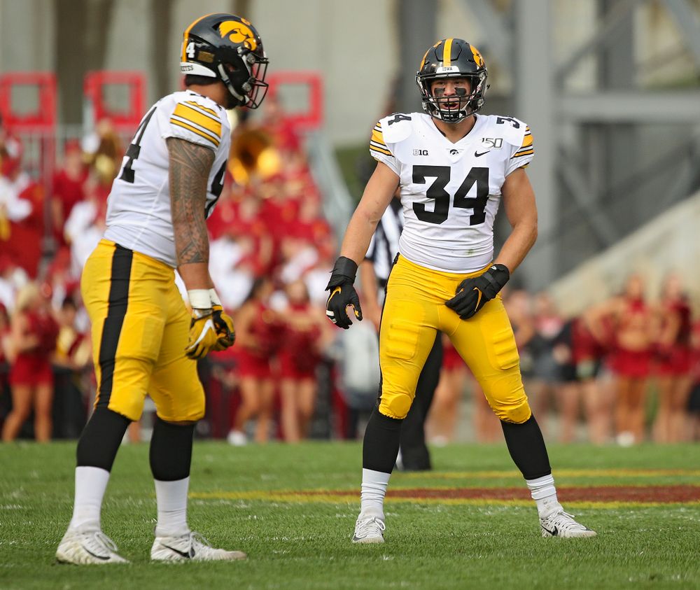 Iowa Hawkeyes defensive end A.J. Epenesa (94) talks with linebacker Kristian Welch (34) before a snap during the first quarter of their Iowa Corn Cy-Hawk Series game at Jack Trice Stadium in Ames on Saturday, Sep 14, 2019. (Stephen Mally/hawkeyesports.com)