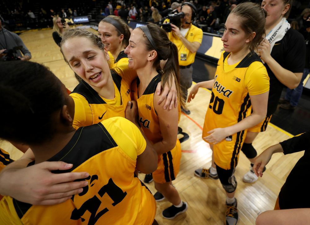Iowa Hawkeyes guard Kathleen Doyle (22) hugs guard Megan Meyer (11) and guard Zion Sanders (21) during senior day activities following their win over the Minnesota Golden Gophers Thursday, February 27, 2020 at Carver-Hawkeye Arena. (Brian Ray/hawkeyesports.com)