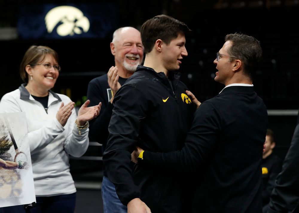Iowa's Mark Springett hugs head coach JD Reive during senior day activities 