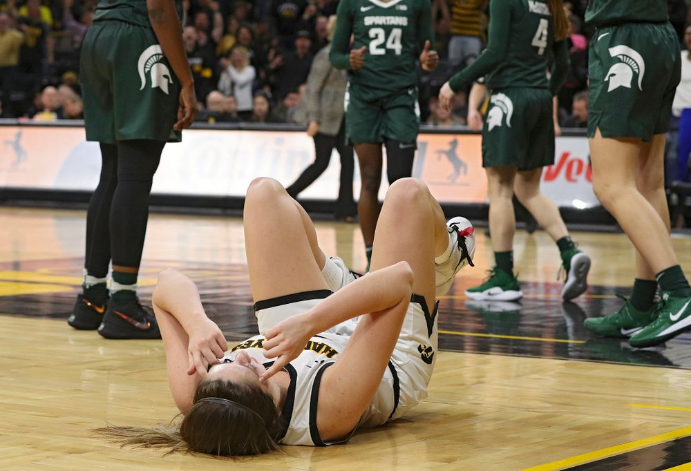 Iowa Hawkeyes guard Mckenna Warnock (14) points to her head as she celebrates after making a basket while being fouled during the fourth quarter of their game at Carver-Hawkeye Arena in Iowa City on Sunday, January 26, 2020. (Stephen Mally/hawkeyesports.com)