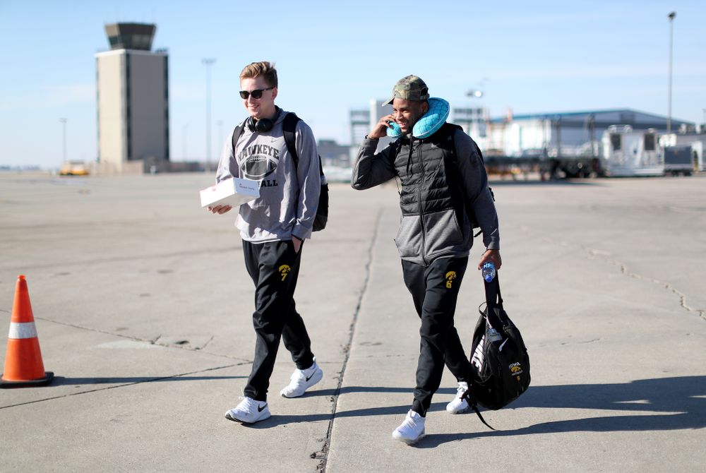 Iowa Hawkeyes quarterback Spencer Petras (7) and wide receiver Ihmir Smith-Marsette (6) board the team plane at the Eastern Iowa Airport Saturday, December 21, 2019 on the way to San Diego, CA for the Holiday Bowl. (Brian Ray/hawkeyesports.com)