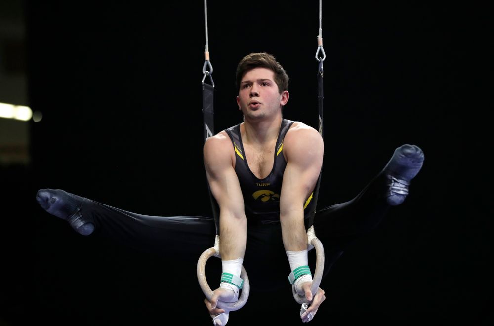 Rogelio Vazquez competes on the rings against Illinois 