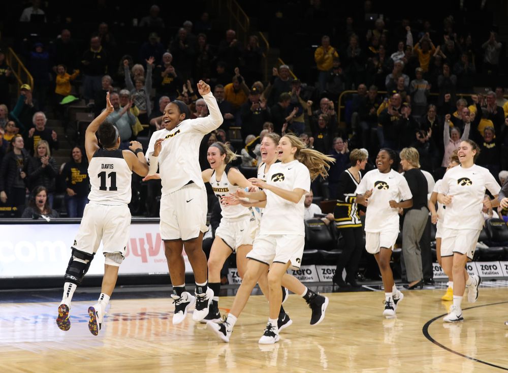 Iowa Hawkeyes guard Tania Davis (11) and guard Alexis Sevillian (5) celebrate their victory over the Rutgers Scarlet Knights Wednesday, January 23, 2019 at Carver-Hawkeye Arena. (Brian Ray/hawkeyesports.com)