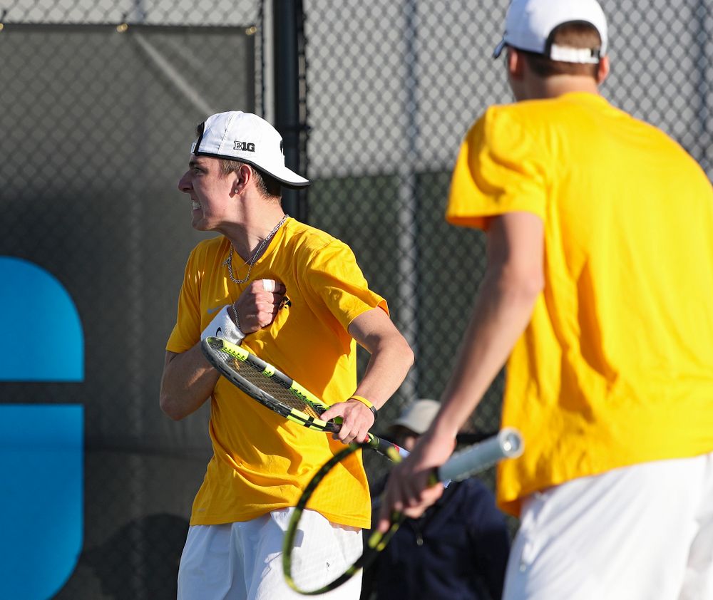 Iowa's Nikita Snezhko (from left) pounds his chest as he celebrates a point with Joe Tyler during their doubles match again Michigan State at the Hawkeye Tennis and Recreation Complex in Iowa City on Friday, Apr. 19, 2019. (Stephen Mally/hawkeyesports.com)