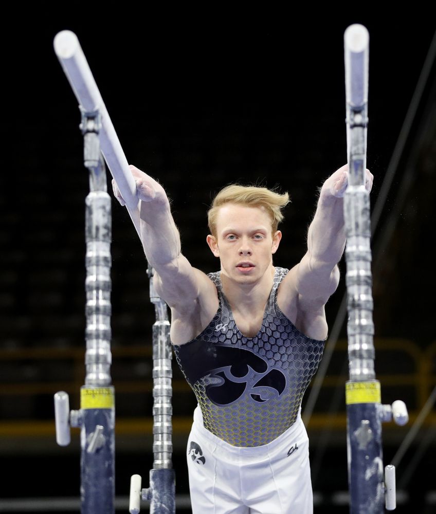 Iowa’s Nick Merryman competes on the parallel bars against Illinois Sunday, March 1, 2020 at Carver-Hawkeye Arena. (Brian Ray/hawkeyesports.com)