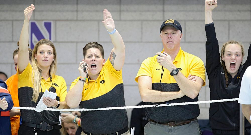 Iowa assistant coach Emma Sougstad (from left), assistant coach/women’s recruiting coordinator Sarah Stockwell-Gregson, and assistant coach/men’s recruiting coordinator Brian Schrader urge on Lauren McDougall (not pictured) as she swims the women’s 500 yard freestyle preliminary event during the 2020 Women’s Big Ten Swimming and Diving Championships at the Campus Recreation and Wellness Center in Iowa City on Thursday, February 20, 2020. (Stephen Mally/hawkeyesports.com)