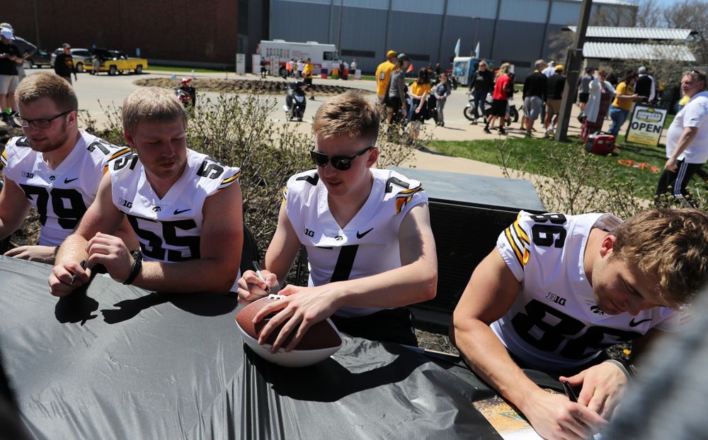 Members of the Iowa Football team sign autographs before the Iowa Hawkeyes game against the Nebraska Cornhuskers Saturday, April 20, 2019 at Duane Banks Field. (Brian Ray/hawkeyesports.com)