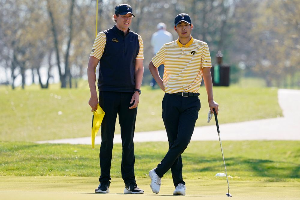 Iowa assistant coach Charlie Hoyle (from left) talks with Joe Kim during the third round of the Hawkeye Invitational at Finkbine Golf Course in Iowa City on Sunday, Apr. 21, 2019. (Stephen Mally/hawkeyesports.com)