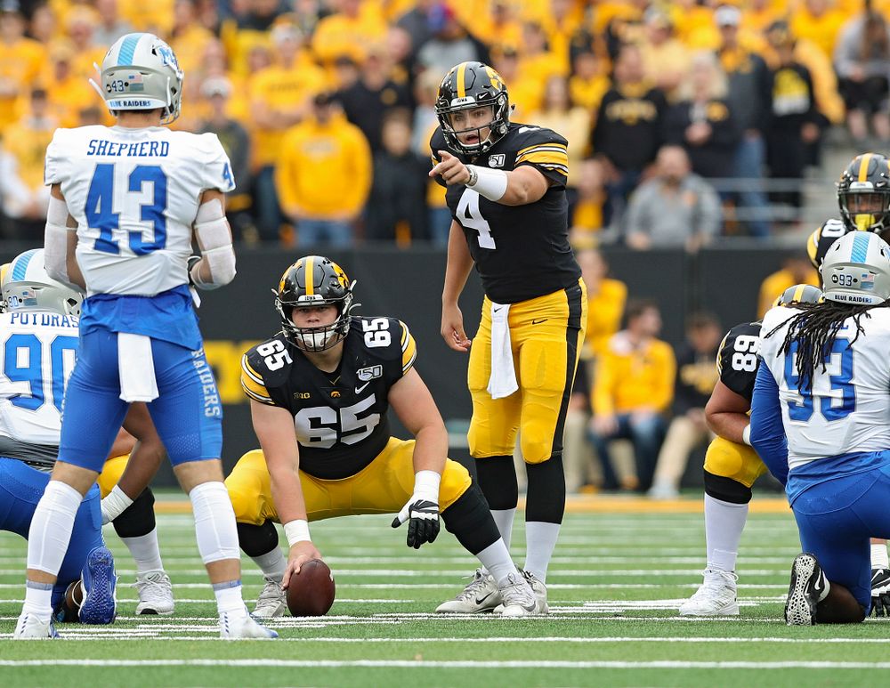 Iowa Hawkeyes quarterback Nate Stanley (4) points across the line as offensive lineman Tyler Linderbaum (65) looks on during the first quarter of their game at Kinnick Stadium in Iowa City on Saturday, Sep 28, 2019. (Stephen Mally/hawkeyesports.com)