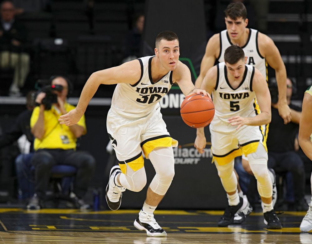 Iowa Hawkeyes guard Connor McCaffery (30) pushes the ball down the court as guard CJ Fredrick (5) and center Luka Garza (55) follow during the first half of their game at Carver-Hawkeye Arena in Iowa City on Sunday, Nov 24, 2019. (Stephen Mally/hawkeyesports.com)