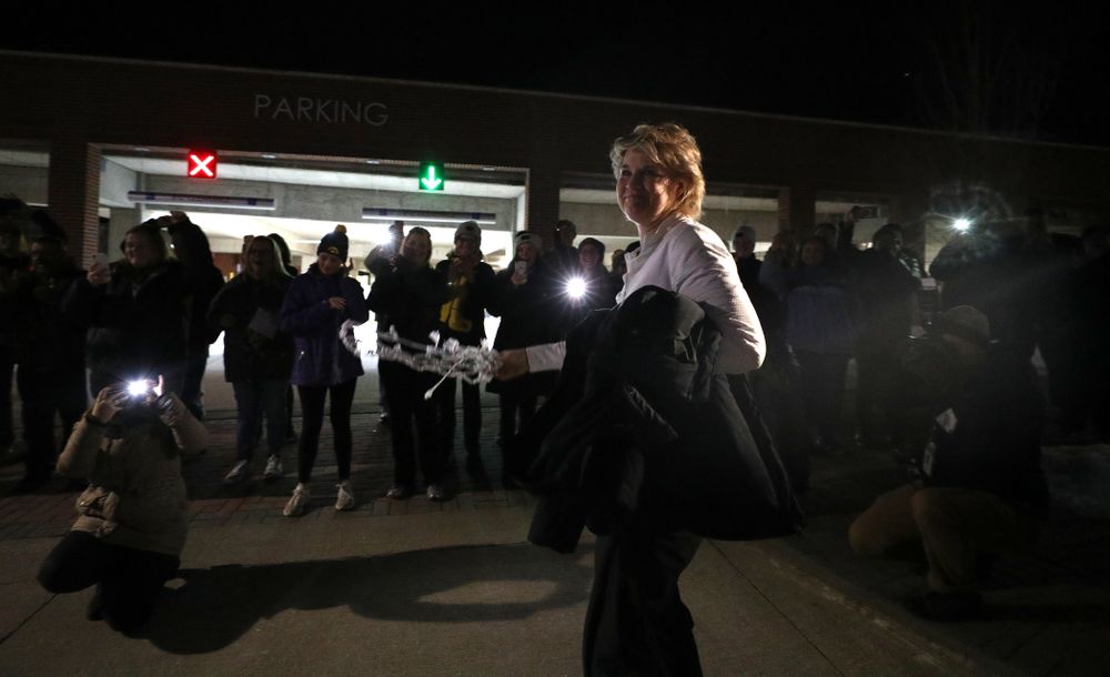 Iowa Hawkeyes head coach Lisa Bluder celebrates with fans as they arrive back in Coralville after defeating the Maryland Terrapins in the Big Ten Championship Game Sunday, March 10, 2019 in Indianapolis, Ind. (Brian Ray/hawkeyesports.com)