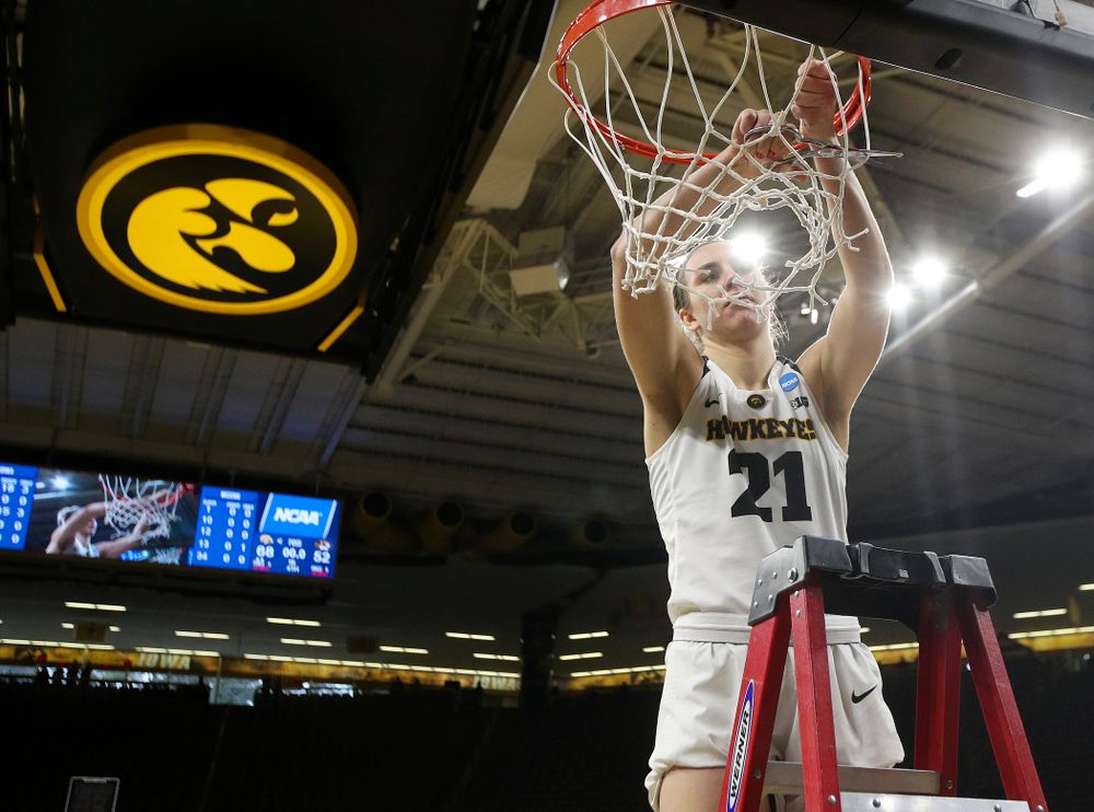 Iowa Hawkeyes forward Hannah Stewart (21) cuts down the net after winning their second round game in the 2019 NCAA Women's Basketball Tournament at Carver Hawkeye Arena in Iowa City on Sunday, Mar. 24, 2019. (Stephen Mally for hawkeyesports.com)