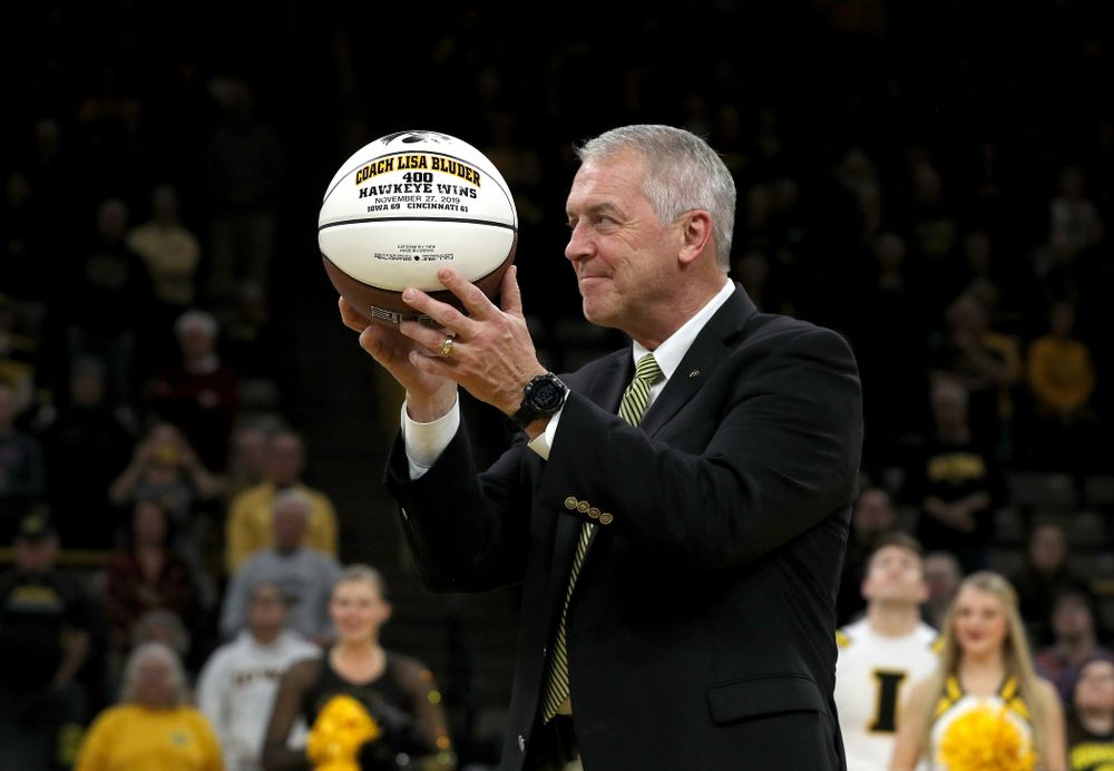 Henry B. and Patricia B. Tippie Director of Athletics Chair Gary Barta presents Iowa Hawkeyes head coach Lisa Bluder with a ceremonial ball commemorating her 400th Hawkeye win before their game against Clemson Wednesday, December 4, 2019 at Carver-Hawkeye Arena. (Brian Ray/hawkeyesports.com)
