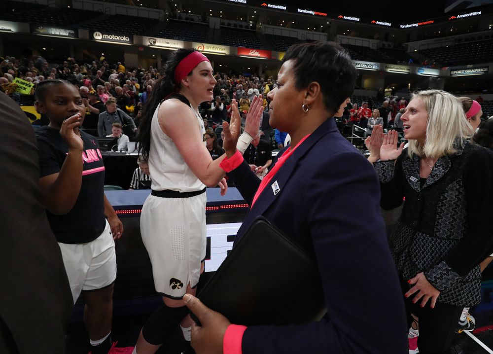 Iowa Hawkeyes forward Megan Gustafson (10) slaps hands with Rutgers Assistant Coach Michelle Edwards following their game in the semi-finals of the Big Ten Tournament Saturday, March 9, 2019 at Bankers Life Fieldhouse in Indianapolis, Ind. (Brian Ray/hawkeyesports.com)