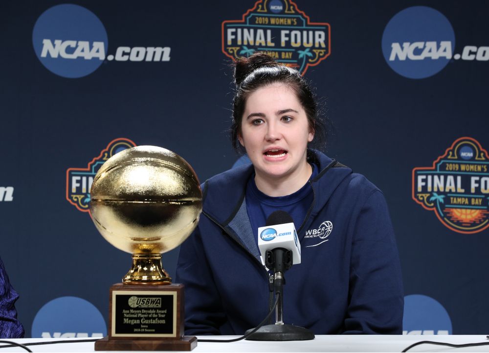 Iowa Hawkeyes forward Megan Gustafson (10) receives US Basketball Writers Association Ann Meyers Drysdale Player of the Year award from Ann Meyers Drysdale during a news conference Friday, April 5, 2019 at Amalie Arena in Tampa, FL. (Brian Ray/hawkeyesports.com)
