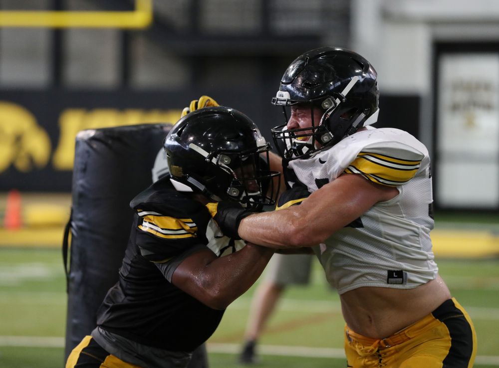 Iowa Hawkeyes running back Ivory Kelly-Martin (21) and linebacker Kristian Welch (34) During Fall Camp Practice No. 6 Thursday, August 8, 2019 at the Ronald D. and Margaret L. Kenyon Football Practice Facility. (Brian Ray/hawkeyesports.com)