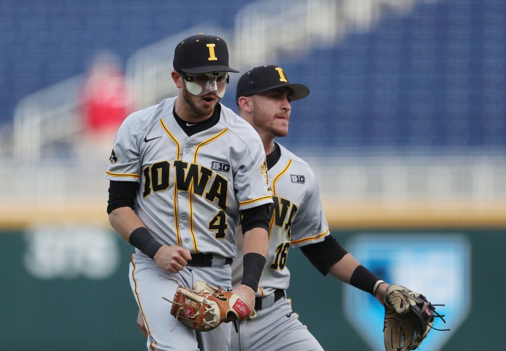 Iowa Hawkeyes Tanner Wetrich (16) and infielder Mitchell Boe (4) celebrate after tuning a double play against the Indiana Hoosiers in the first round of the Big Ten Baseball Tournament Wednesday, May 22, 2019 at TD Ameritrade Park in Omaha, Neb. (Brian Ray/hawkeyesports.com)