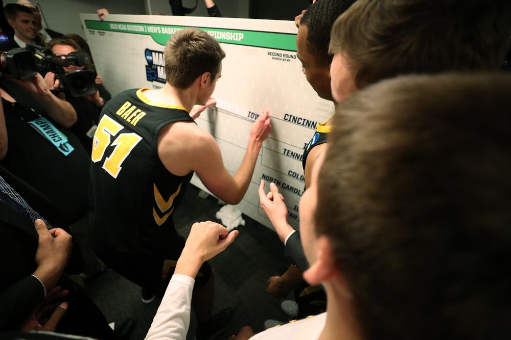 Iowa Hawkeyes forward Nicholas Baer (51) advances the team on the bracket following their game against the Cincinnati Bearcats in the first round of the 2019 NCAA Men's Basketball Tournament Friday, March 22, 2019 at Nationwide Arena in Columbus, Ohio. (Brian Ray/hawkeyesports.com)