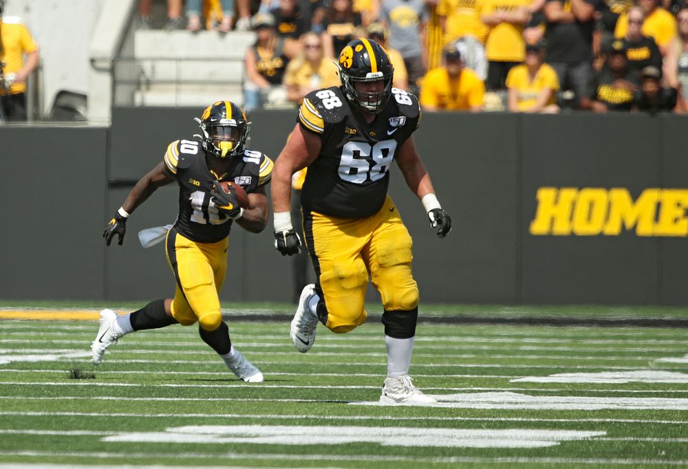 Iowa Hawkeyes running back Mekhi Sargent (10) runs after pulling in a pass as offensive lineman Landan Paulsen (68) looks to block during the third quarter of their Big Ten Conference football game at Kinnick Stadium in Iowa City on Saturday, Sep 7, 2019. (Stephen Mally/hawkeyesports.com)
