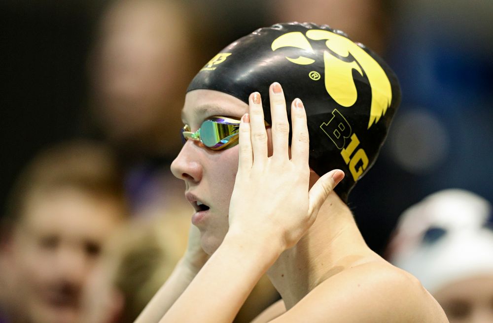 Iowa’s Macy Rink adjusts her cap before swimming the women’s 200 yard freestyle C final event during the 2020 Women’s Big Ten Swimming and Diving Championships at the Campus Recreation and Wellness Center in Iowa City on Friday, February 21, 2020. (Stephen Mally/hawkeyesports.com)