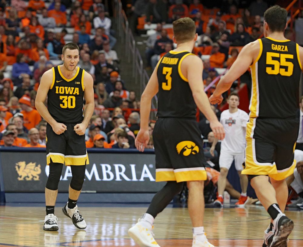 Iowa Hawkeyes guard Connor McCaffery (30) is pumped up as he walks to his team’s bench for a timeout after making a 3-pointer during the second half of their ACC/Big Ten Challenge game at the Carrier Dome in Syracuse, N.Y. on Tuesday, Dec 3, 2019. (Stephen Mally/hawkeyesports.com)