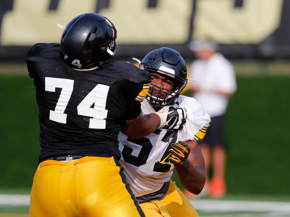 Iowa Hawkeyes defensive end Chauncey Golston (57) and offensive lineman Tristan Wirfs (74) during camp practice No. 16 Tuesday, August 21, 2018 at the Hansen Football Performance Center. (Brian Ray/hawkeyesports.com)