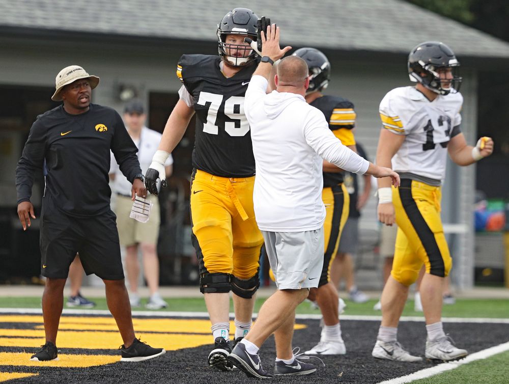 Iowa Hawkeyes offensive lineman Jack Plumb (79) gets a high-five from offensive line coach Tim Polasek  durning Fall Camp Practice No. 17 at the Hansen Football Performance Center in Iowa City on Wednesday, Aug 21, 2019. (Stephen Mally/hawkeyesports.com)