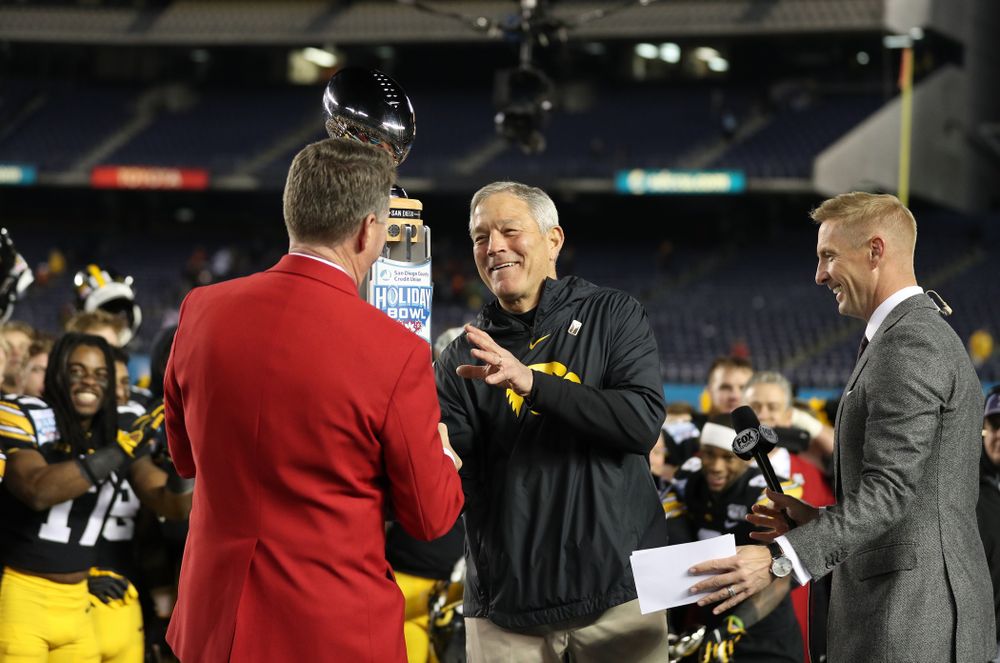 Iowa Hawkeyes head coach Kirk Ferentz is presented with the Holiday Bowl trophy following their win against USC in the Holiday Bowl Friday, December 27, 2019 at San Diego Community Credit Union Stadium.  (Brian Ray/hawkeyesports.com)